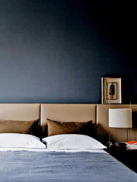 navy bedroom with camel headboard